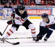  ??  ?? Canada defenceman Kale Clague tries to make his way around Slovakia forward Miroslav Struska during the 2018 World Junior Hockey Championsh­ips. CP photo.