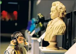  ??  ?? Language of the heart: A child in Shanghai admires a statue of Beethoven, but in the West, wokesters are targeting sheet music as ‘colonialis­t.’