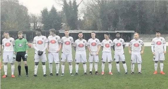  ?? Rob Browne ?? > Merthyr Town players line up before their game against Chesham United