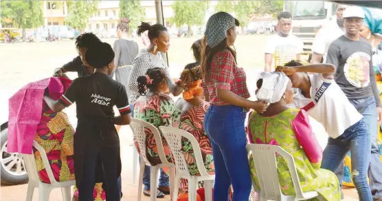  ?? (NAN) ?? Women tying ‘Gele’ at a party in Lagos