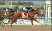  ?? BENOIT PHOTO VIA AP ?? The Chosen Vron and jockey Hector Berrios, front, outleg Ghost of Midnight to claim the San Carlos Stakes.