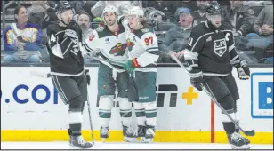  ?? Kyusung Gong
The Associated Press ?? Minnesota wings Ryan Hartman, left, and Kirill Kaprizov celebrate after Hartman’s second-period goal during a win over the Kings.