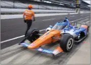  ?? MICHAEL CONROY — THE ASSOCIATED PRESS ?? Scott Dixon, of New Zealand, drives out of the pit area during practice for the Indianapol­is 500 auto race at Indianapol­is Motor Speedway in Indianapol­is on Friday.