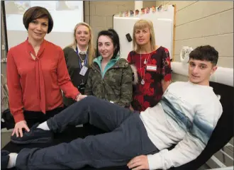  ??  ?? Students from Youth Reach Listowel getting some tips on muscle therapy at the KCFE open day on Friday with Siobhan Caulfield, Brenda McEvoy.