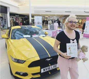  ?? ?? Richie Smith alongside his Mustang sports car and holding his book, The Art of Weeing In The Sink.