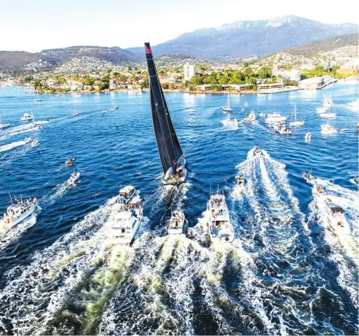  ??  ?? In a photo provided by Role, Comanche, centre, is surrounded by spectator craft on arrival at Hobart, Australia, to claim victory in the Sydney to Hobart yacht race yesterday