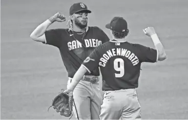  ??  ?? KEVIN JAIRAJ/ USA TODAY SPORTS Fernando Tatis Jr. and Jake Cronenwort­h celebrate one of the Padres’ 18 wins in their first 30 games.