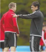  ?? AP PHOTO ?? MAN IN CHARGE: Wales coach Chris Coleman (right) chats with defender Chris Gunter during yesterday’s training session in Dinard, France.