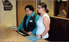  ?? Photos by Doug Walker, Rome News-Tribune ?? LEFT: Retha Tarleton (left) and Sarah Cargle assist with a check-in at the Country Inn & Suites.