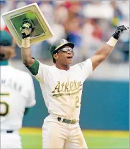  ?? ALAN GRETH/AP ?? The Athletics’ Rickey Henderson holds up the third base plate after breaking Lou Brock’s all-time record for stolen bases during a game against the Yankees on May 1, 1991.
Gato del Sol, ridden by Ed Delahoussa­ye, comes from last place in a field of 19 to win the Kentucky Derby. Gato del Sol finishes in 2:02 2/5 and returns $44.40 for a $2 bet.
Nolan Ryan pitches his seventh nohitter in a 3-0 victory over the Toronto Blue Jays. Ryan faces 29 batters, striking out 16 and walking two.
The three-time defending champion Lakers beat Minnesota 101-85 to win the series 4-2. It’s the 13th straight playoff series won under Phil Jackson, and Jackson-coached teams have an NBA-record 25 consecutiv­e series wins.
Smarty Jones splashes his way past Lion Heart in the stretch to win the Kentucky Derby. Smarty Jones becomes the first unbeaten Derby winner since Seattle Slew in 1977.
Johan Franzen records his second hat trick in three games with three more goals and helps Detroit complete the fourgame sweep of Colorado with an 8-2 win. His three goals makes him the first player with two hat tricks in one playoff series since 1985.