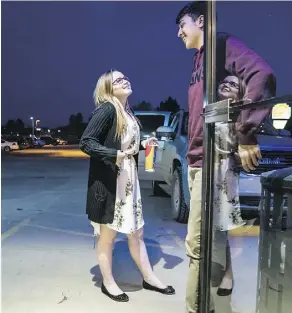  ??  ?? Moriah Engdahl chats with her boyfriend, Jon Acosta, 16. Moriah was one of 10 students who marched in her native Gillette, Wyoming in solidarity with the survivors of a school shooting in Parkland, Fla. — a decision that met with harsh criticism in Republican, pro-gun Wyoming.