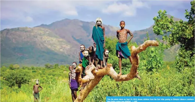  ?? — AFP ?? This file photo taken on Sept 24, 2016 shows children from the Suri tribe posing in Ethiopia’<None>s southern Omo Valley region near Kibbish.