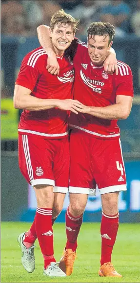  ??  ?? GEARED UP: Aberdeen’s Ash Taylor (left) and goal hero Andrew Considine celebrate in Croatia at full-time after their stunning 3-0 victory over Rijeka