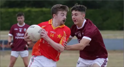  ??  ?? Floyd Murphy (Starlights) is tackled by Conor Kelly (St. Martin’s) in Wednesday’s Under-20 Division 1A game in Piercestow­n.