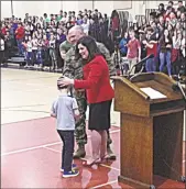  ??  ?? Stotler greets his wife, Michele, and son, James Jr.