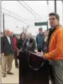  ??  ?? Leonard Bonarek, regional planner for the Bicycle Coalition of Greater Philadelph­ia, far right, speaks on Friday about the completion of new bicycle lanes on three suburban state highways in the Philadelph­ia region.
