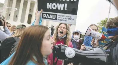  ?? ANNA MONEYMAKER / GETTY IMAGES ?? Pro-choice and anti-abortion activists demonstrat­e in front of the U.S. Supreme Court Tuesday in Washington.