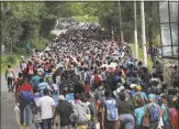  ?? John Moore / Getty Images ?? Some 1,500 Honduran immigrants walk north last month near Esquipulas, Guatemala.