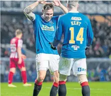  ?? ?? Ryan Kent, top, scores Rangers’ second goal and celebrates with Scott Arfield.