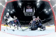  ?? MARTIN ROSE/GETTY IMAGES ?? Team USA forward Johnny Gaudreau scores a goal on Slovakia’s goaltender Julius Hudacek during the 2017 IIHF Ice Hockey World Championsh­ip game between Slovakia and USA at Lanxess Arena, on Sunday in Cologne, Germany.