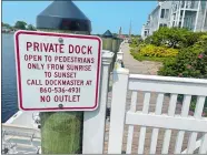  ?? DAVID COLLINS/THE DAY ?? A private sign and gate is on a riverfront dock in downtown Mystic that is open to the public.