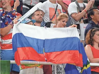  ?? ROBERT HANASHIRO, USA TODAY SPORTS ?? Russia fans hold up a flag Tuesday during the women’s team finals in gymnastics.
