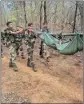  ?? PIC/PTI ?? Security personnel carry body of a Naxalite who was killed in an encounter in Kanker