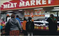  ?? STAFF ARCHIVES ?? Shoppers wait in line at the meat counter at a market in Oakland in March. Highly trafficked indoor businesses that limit capacity could help slow the spread of COVID-19, according to a study released Tuesday.