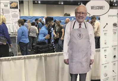  ?? ?? A cutout of Berkshire Hathaway CEO Warren Buffett greets shareholde­rs at the Pampered Chef booth at the company’s annual meeting, Friday, APril 29, 2022, in Omaha. Tens of thousands of shareholde­rs are expected Saturday to attend the company’s first in-person meeting since the pandemic began.