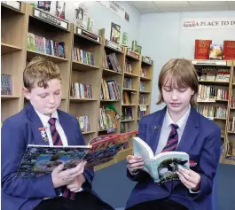  ??  ?? Mackenzie Harnett, 13 and Literacy Champion Megan Lucas, 13, in the new Reading Room at Whitworth Community High