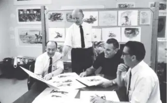  ?? Courtesy of Disney ?? Xavier “X” Atencio, right, in the 1960s joins fellow Disney Legends and Imagineers, from left, Marc Davis, Richard Irvine and Claude Coats in reviewing concept artwork for Country Bear Jamboree at Disneyland and the as-yet-unopened Walt Disney World.
