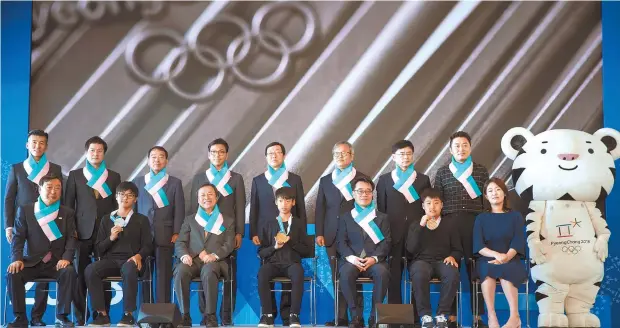  ?? Yonhap ?? The 2018 PyeongChan­g Winter Olympic medals are unveiled at a ceremony at Dongdaemun Design Plaza in Seoul, Thursday.