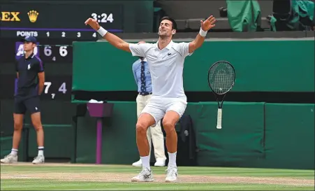  ?? AFP ?? Serbia’s Novak Djokovic celebrates defeating Italy’s Matteo Berrettini in the Wimbledon men’s singles final in London on Sunday. The world No 1 triumphed 6-7 (4), 6-4, 6-4, 6-3.