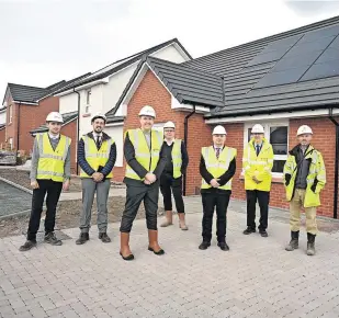  ?? ?? Building the future North Lanarkshir­e Council leader Jordan Linden (front) visits a new property