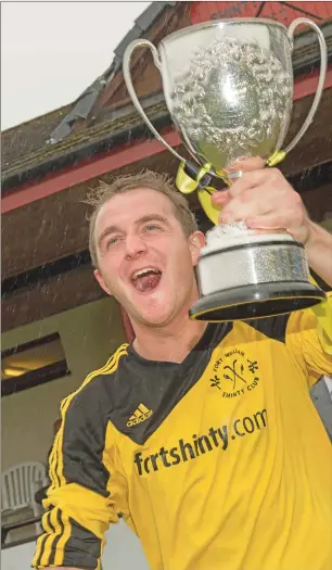  ??  ?? A delighted Fort William captain James Tangney with the Balliemore Cup.