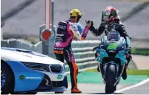  ??  ?? LEFT: Morbidelli being congratula­ted by Moto3 rider Migno