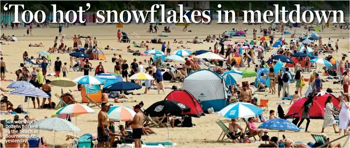  ?? ?? Sun worship: Dozens flocked to the beach at Bournemout­h yesterday