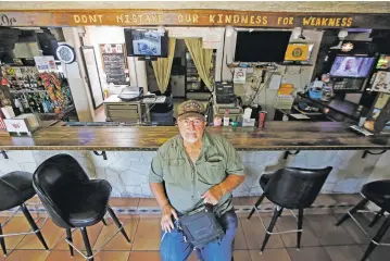  ?? PHOTOS BY LUIS SÁNCHEZ SATURNO/THE NEW MEXICAN ?? Harold Durr, commander of the American Legion Montoya y Montoya Post 1, sits Monday at the post’s bar. Durr has asked the community for help keeping the post open, which is struggling during the pandemic closures.