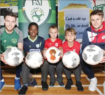  ??  ?? John Russell, FAI Regional Developmen­t Officer, Regan Donelon, Sligo Rovers with children at St. John’s NS. Pics: Carl Brennan.