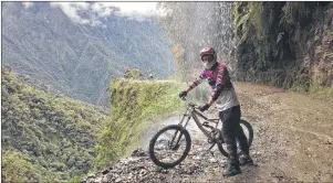  ?? JAMES FLETCHER/CP PHOTO ?? James Fletcher poses while mountain biking down the death road in Bolivia in an undated handout photo. Two years ago he departed Toronto for a year-long adventure to 21 countries, where he mountain biked down Bolivia’s “death road”, watched a cricket...