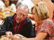  ??  ?? It’s all fun, games and beach balls at a Gathering Place session for Alzheimer’s sufferers and other disabled people at Lakewood United Methodist Church. “Care partner” Walter Blake, left, works on a craft project with volunteer Lu Henske.