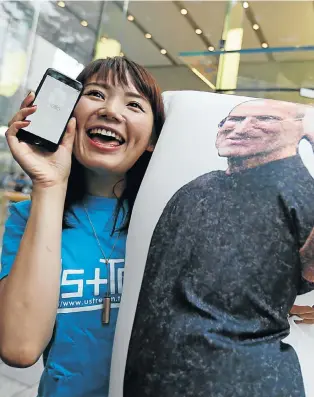  ?? Picture: REUTERS ?? IN STEVE iTRUST: Ayano Tominaga poses with her new iPhone 7 after purchasing it at the Apple Store in Tokyo’s Omotesando shopping district on Friday