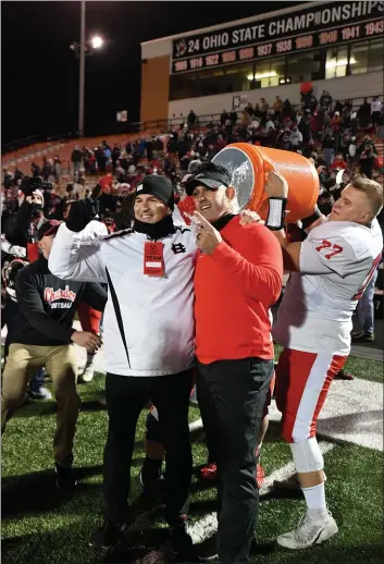  ?? PAUL DICICCO - FOR THE NEWS-HERALD ?? Chardon football coach Mitch Hewitt gets doused with the water bucket after the Hilltopper­s’ state championsh­ip win over Columbus DeSales.