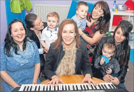  ??  ?? Tara Palmer Tomkinson plays the piano for children at Speur Ghlan’s Bridge of Allan base.