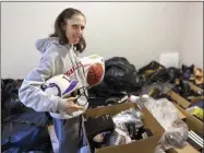  ?? TERESA WALKER - THE ASSOCIATED PRESS ?? Rhiannon Potkey displays sports equipment Jan. 30, 2021, in Knoxville, Tenn. Goods4Grea­tness, the nonprofit started by Potkey, works to get much-needed gear to low-income children and teens to make sure the high cost of equipment doesn’t stop their athletic dreams.