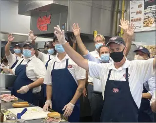  ?? SUBMITTED PHOTO ?? Jersey Mike’s Subs Founder and CEO Peter Cancro, in blue shirt, at a Jersey Mike’s Subs location on the company’s 2021 Day of Giving, March 31. The company raised a record $15 million during the month-long fundraisin­g effort.