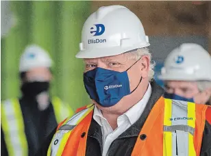  ?? FRANK GUNN THE CANADIAN PRESS ?? Ontario Premier Doug Ford arrives on a constructi­on site in Toronto on Thursday. Ford said the province was considerin­g a plea from two hot spots — Toronto and Peel Region — to stay locked down for two more weeks.