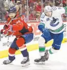  ?? AL DRAGO/AP ?? Capitals defenseman Jonas Siegenthal­er, left, races Canucks center Zack MacEwen for the puck Saturday.