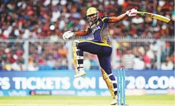  ?? AFP ?? Andre Russell of Kolkata Knight Riders tries to keep his balance next to the stumps during his 25-ball 49 against Rajasthan Royals in the first eliminator at The Eden Gardens in Kolkata.