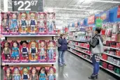  ?? Associated Press file photo ?? Most holiday shopping still will occur in stores, such as this Walmart, experts say. But online sales are expected to set a record, $124.1 billion, this year.